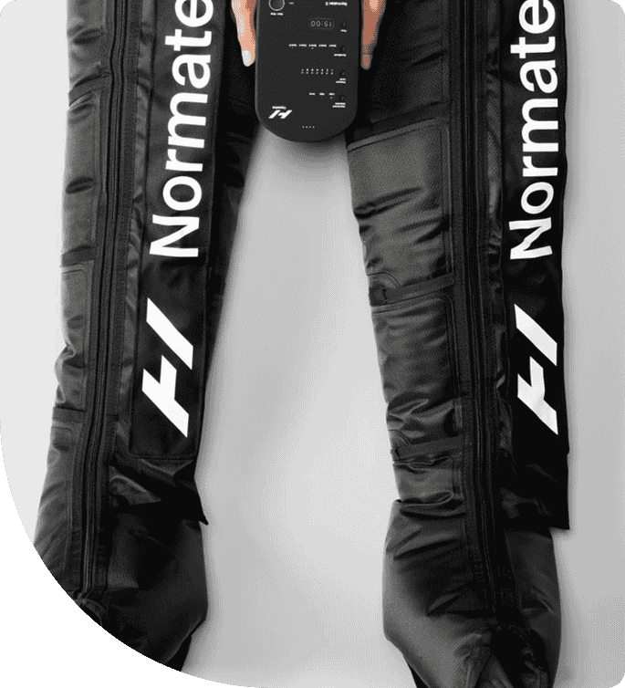 Normatec compression boots with control device, designed for muscle recovery and circulation enhancement in a wellness environment.