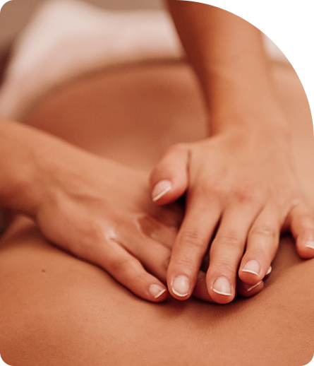 Hands performing a remedial massage on a person's back, emphasizing relaxation and recovery in a wellness setting.