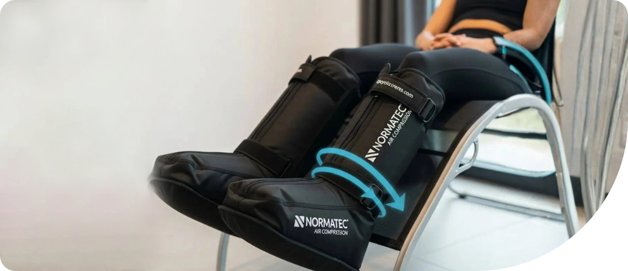 Normatec compression boots on a user, showcasing pneumatic recovery technology for muscle recovery and circulation enhancement.