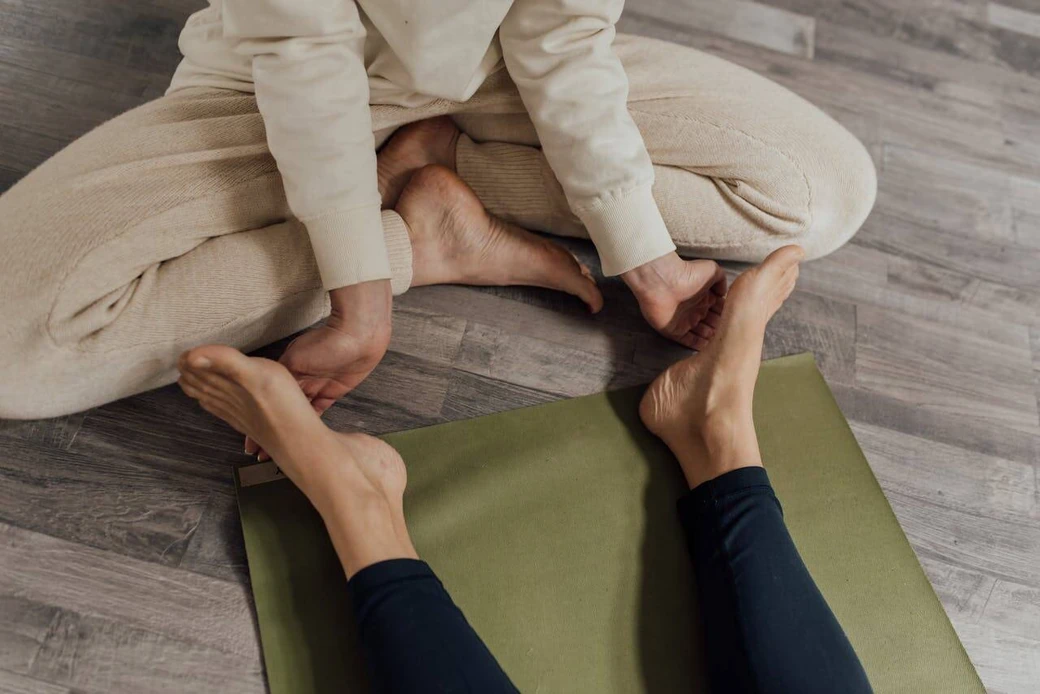 Person demonstrating foot exercises for plantar fasciitis, focusing on stretching and strengthening techniques on a yoga mat, promoting heel pain relief and foot stability.